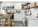 Bright kitchen featuring white cabinets, stainless steel appliances, and butcher block island with seating at 912 E Orchid Ln, Phoenix, AZ 85020