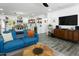 Inviting living room with comfortable blue couches, open kitchen, and a modern ceiling fan at 912 E Orchid Ln, Phoenix, AZ 85020