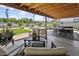 Charming outdoor patio, featuring overhead lighting, multiple seating areas, and manicured landscaping at 912 E Orchid Ln, Phoenix, AZ 85020