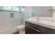 Modern bathroom featuring subway tile in shower/tub combination with a dark vanity and neutral fixtures at 9371 E Wood Dr, Scottsdale, AZ 85260
