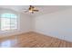 Bright bedroom with hardwood floors, a ceiling fan, and a large window at 9371 E Wood Dr, Scottsdale, AZ 85260