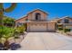Charming two-story home with a well-maintained front yard and a two-car garage and desert landscaping at 9371 E Wood Dr, Scottsdale, AZ 85260