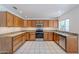 Well-lit kitchen featuring light wood cabinets, modern stainless steel appliances, and granite countertops at 9371 E Wood Dr, Scottsdale, AZ 85260