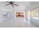 Open concept living room with tile floors, leading to a well-lit kitchen with light wood cabinets at 9371 E Wood Dr, Scottsdale, AZ 85260