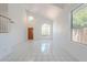 Bright living room with high ceilings and a large window, complemented by white ceramic tile floors at 9371 E Wood Dr, Scottsdale, AZ 85260