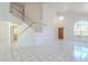 Bright living room with high ceilings, a staircase, large windows and ceramic tile floors at 9371 E Wood Dr, Scottsdale, AZ 85260