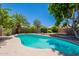 Private backyard pool surrounded by mature trees and landscaping, creating a serene oasis at 9371 E Wood Dr, Scottsdale, AZ 85260