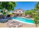 Inviting backyard pool with covered patio and lush landscaping, perfect for outdoor relaxation at 9371 E Wood Dr, Scottsdale, AZ 85260