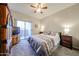 Comfortable bedroom with neutral color scheme, ceiling fan, and balcony access at 10030 W Indian School Rd # 101, Phoenix, AZ 85037