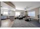 Open concept living room with plush carpeting and a view to the kitchen at 10030 W Indian School Rd # 101, Phoenix, AZ 85037