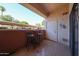 Cozy outdoor patio with a pair of chairs and small table perfect for relaxing at 10030 W Indian School Rd # 101, Phoenix, AZ 85037