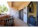 This outdoor patio space includes a pair of chairs and small table with a view at 10030 W Indian School Rd # 101, Phoenix, AZ 85037