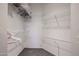 This walk-in closet features multiple shelves and hanging racks for ample storage at 10030 W Indian School Rd # 101, Phoenix, AZ 85037