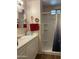 Bathroom with a shower, vanity with dual mirrors, storage and a towel rack with festive heart decorations at 120 N Val Vista Dr # 196, Mesa, AZ 85213