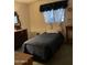 Modest bedroom with a single bed, dresser, and window with curtains at 120 N Val Vista Dr # 196, Mesa, AZ 85213