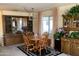 Traditional dining room with a wooden table set, chandelier, and decorative display cabinets at 120 N Val Vista Dr # 196, Mesa, AZ 85213