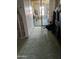 Hallway with a green carpet, floor-to-ceiling storage cabinets, and access to an outdoor patio area at 120 N Val Vista Dr # 196, Mesa, AZ 85213