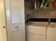 Laundry room with a louvered door, washer, dryer and shelving with storage, cleaner and other items at 120 N Val Vista Dr # 196, Mesa, AZ 85213