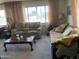 Cozy living room featuring comfortable seating, a wood coffee table, and natural light from the large window at 120 N Val Vista Dr # 196, Mesa, AZ 85213