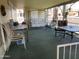 Outdoor patio seating area with multiple tables, chairs, a porch swing and a green outdoor carpet at 120 N Val Vista Dr # 196, Mesa, AZ 85213