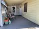 Covered porch with chairs, planters, and decor near the front entrance at 120 N Val Vista Dr # 196, Mesa, AZ 85213