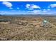 Scenic aerial shot of a developing desert community set against a backdrop of mountains and expansive blue skies at 12746 E Casitas Del Rio E Dr, Scottsdale, AZ 85255