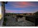 Backyard featuring stone pavers, a modern fireplace and views of the nearby hills in the background at 12746 E Casitas Del Rio E Dr, Scottsdale, AZ 85255