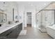 Modern bathroom featuring double vanity, walk-in shower, and soaking tub with luxury finishes at 12746 E Casitas Del Rio E Dr, Scottsdale, AZ 85255
