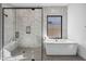 Bathroom featuring a glass shower, modern tub, and luxurious marble finishes at 12746 E Casitas Del Rio E Dr, Scottsdale, AZ 85255