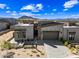 Aerial view of a desert home featuring contemporary design, a paved driveway, and beautiful mountain views at 12746 E Casitas Del Rio E Dr, Scottsdale, AZ 85255