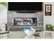 Close-up view of a modern fireplace beneath a television in the beautifully designed living room at 12746 E Casitas Del Rio E Dr, Scottsdale, AZ 85255