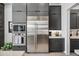 Close-up showcasing stainless steel fridge, oven, and gray cabinetry in the well-appointed kitchen at 12746 E Casitas Del Rio E Dr, Scottsdale, AZ 85255