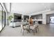 Open-concept living area featuring a cozy living room and glass dining table adjacent to the modern kitchen at 12746 E Casitas Del Rio E Dr, Scottsdale, AZ 85255
