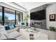 Bright living room with a fireplace, mounted TV, comfortable seating, and a view to the exterior at 12746 E Casitas Del Rio E Dr, Scottsdale, AZ 85255