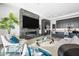 Cozy living space featuring a modern fireplace, mounted television, and adjacent kitchen at 12746 E Casitas Del Rio E Dr, Scottsdale, AZ 85255