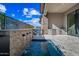 Outdoor living area with pool, waterfall feature, outdoor kitchen, and covered patio space at 12746 E Casitas Del Rio E Dr, Scottsdale, AZ 85255