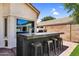 Backyard bar with countertop and stools, perfect for outdoor entertaining and gatherings at 1332 W Blue Ridge Ct, Chandler, AZ 85248
