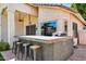 Covered outdoor bar area with barstool seating, ideal for entertaining and enjoying the outdoors at 1332 W Blue Ridge Ct, Chandler, AZ 85248