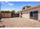 Low-maintenance backyard with a sliding door, gravel landscape, and perimeter wall at 1332 W Blue Ridge Ct, Chandler, AZ 85248