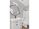 Modern bathroom boasts a round mirror, single sink vanity, and a shower-tub combo with white tile at 1332 W Blue Ridge Ct, Chandler, AZ 85248