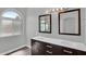 Bathroom features dual sinks, stylish mirrors, and a large arched window for natural light at 1332 W Blue Ridge Ct, Chandler, AZ 85248
