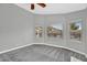 Bedroom with neutral carpeting, three windows with blinds, and ceiling fan at 1332 W Blue Ridge Ct, Chandler, AZ 85248