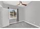 Bright bedroom with a ceiling fan, neutral gray walls, plush carpet, and a sunlit window at 1332 W Blue Ridge Ct, Chandler, AZ 85248