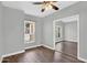 Light bedroom shows wood floors, window, trim, ceiling fan and is adjacent to another light bedroom at 1332 W Blue Ridge Ct, Chandler, AZ 85248
