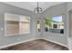 Sunlit dining area featuring dark wood floors and large windows overlooking the backyard at 1332 W Blue Ridge Ct, Chandler, AZ 85248