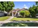 Well-maintained single-story home features mature shade trees, green lawn, and a walkway at 1332 W Blue Ridge Ct, Chandler, AZ 85248