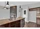 Modern kitchen with stainless appliances, granite countertops, and a view into the living area at 1332 W Blue Ridge Ct, Chandler, AZ 85248