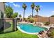 Tranquil backyard showcases a sparkling pool, rock features, and shade, perfect for relaxation at 1332 W Blue Ridge Ct, Chandler, AZ 85248