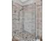 Modern glass-enclosed shower with mosaic tile floor and large format tile walls at 1332 W Blue Ridge Ct, Chandler, AZ 85248