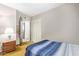 Bedroom featuring a blue-striped bed, closet, nightstand with lamp, and an open doorway at 1351 E Ellis Cir, Mesa, AZ 85203